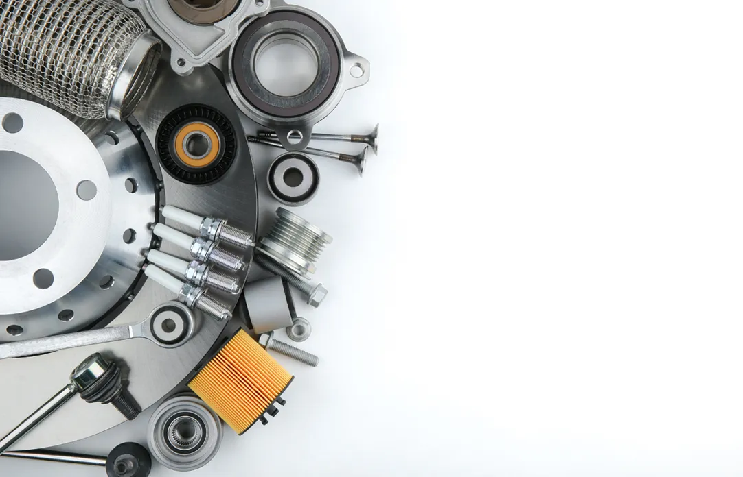 Assorted car spare parts arranged on a workbench